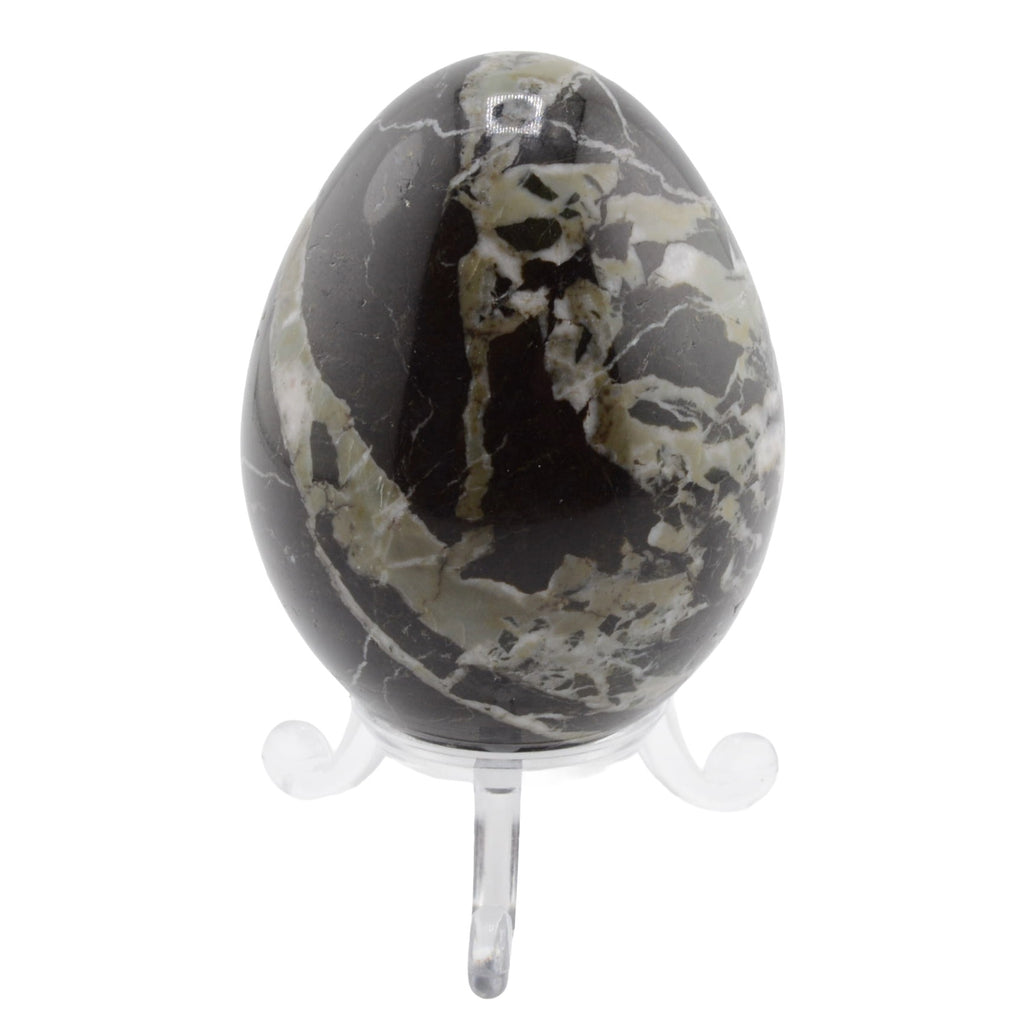 A polished black marblestone egg with natural green and white veining, displayed on a clear acrylic stand against a white background.