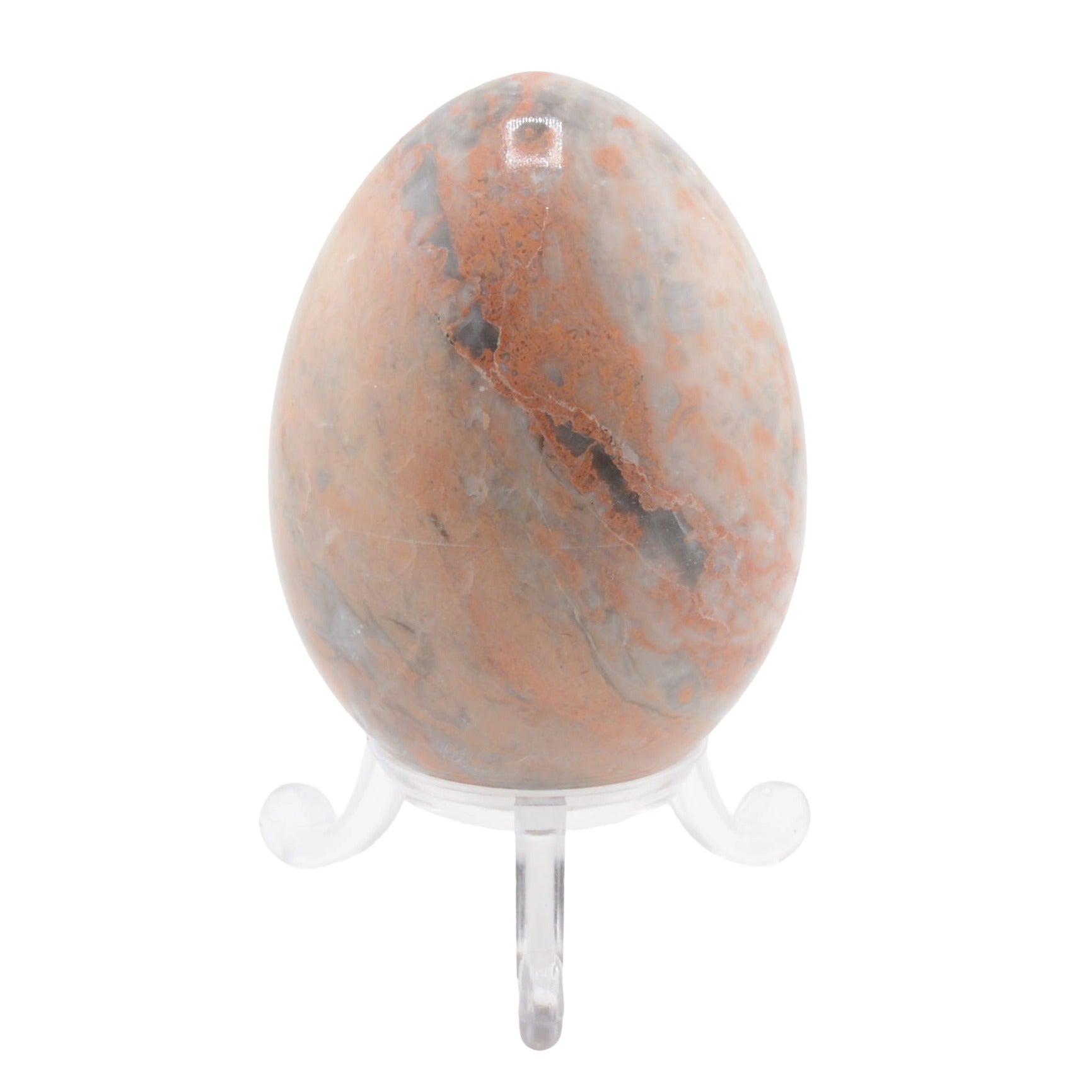 A polished natural stone egg with orange, brown, and gray marbling, displayed on a clear acrylic stand against a white background.
