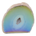 A polished natural aura agate geode specimen with concentric bands of pale green, light blue, and violet-purple, with a rough tan outer matrix and a small crystalline druzy core, shown on a plain white background.