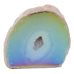 A polished natural aura agate geode specimen with concentric bands of pale green, light blue, and violet-purple, with a rough tan outer matrix and a small crystalline druzy core, shown on a plain white background.