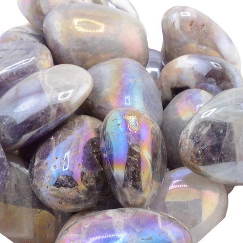A pile of polished aura amethyst tumbled stones with a smooth, rounded shape and an iridescent sheen showing purple, blue, green, and gold reflections.