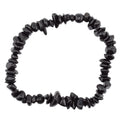 A black tourmaline gemstone chip bead bracelet made of polished irregular dark beads, photographed on a plain white background.