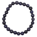 A beaded stretch bracelet made of dark, polished blue goldstone round beads, arranged in a circle on a plain white background.