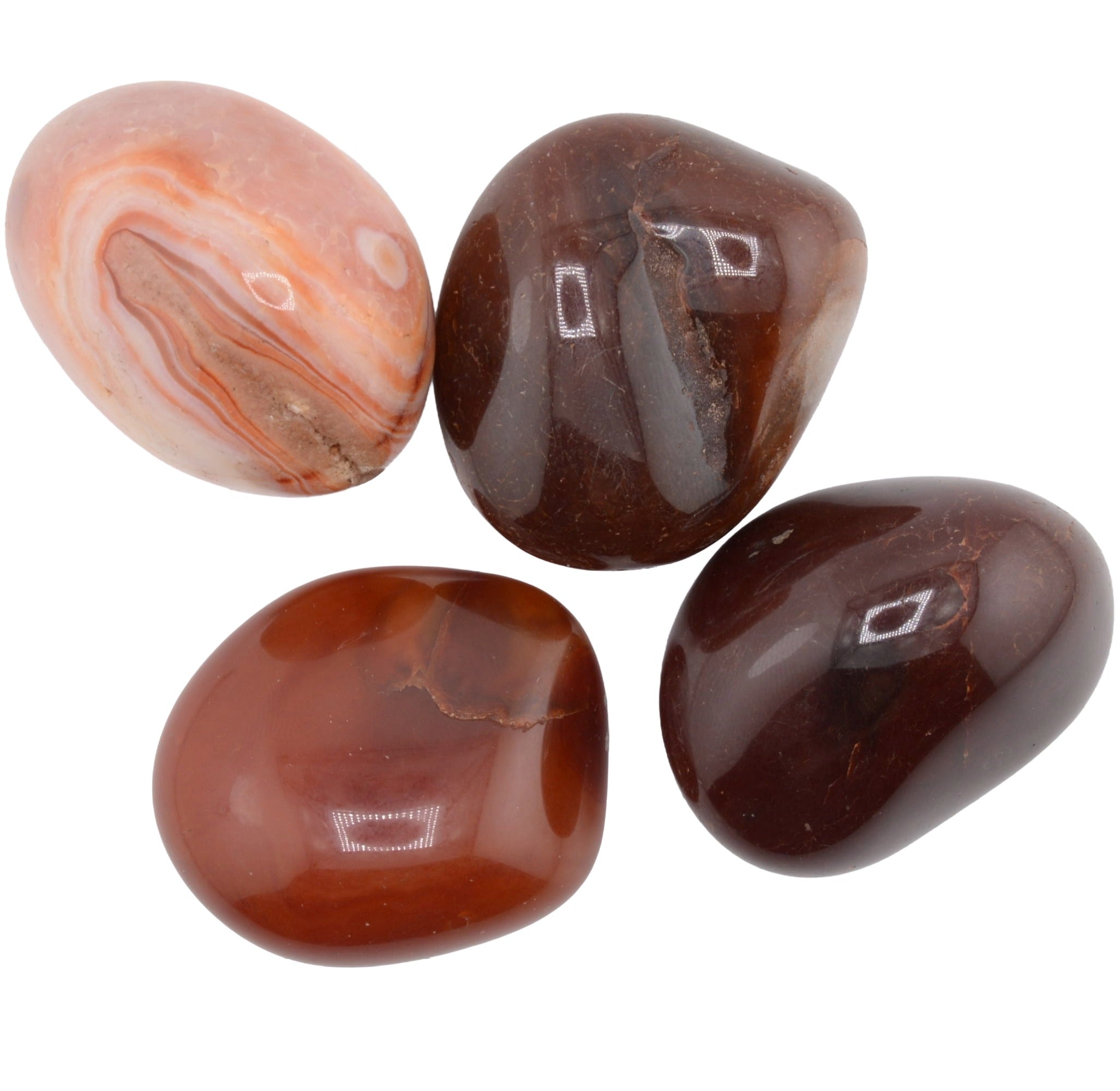 Four polished carnelian tumbled gemstones in earthy brown, reddish-brown, and peach-orange tones, arranged on a plain white background.