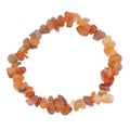 A beaded stretch bracelet made of small, irregular carnelian gemstone chips, arranged in a circle on a plain white background.