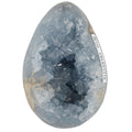 A Blue Celestite Grystal Geode Egg displayed against a plain white background.