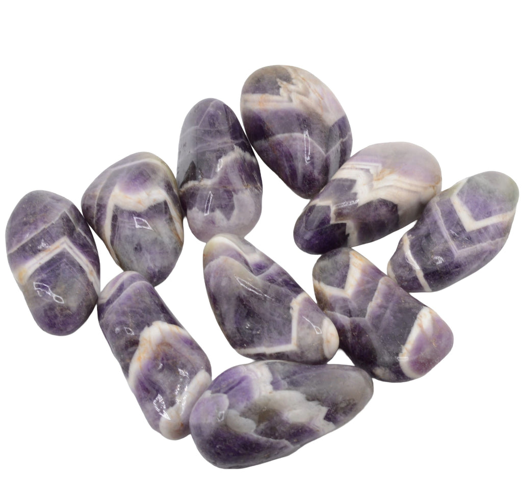 A group of polished chevron amethyst purple and white marbled tumbled stones, arranged on a plain white background.
