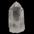 A natural clear quartz crystal point with visible internal inclusions and a rough, unpolished base, photographed against a solid black background.