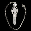 A silver-toned chain necklace featuring a pointed quartz crystal pendant and merkaba, a decorative silver filigree frame, and a round clear stone at the top, displayed against a solid black background.