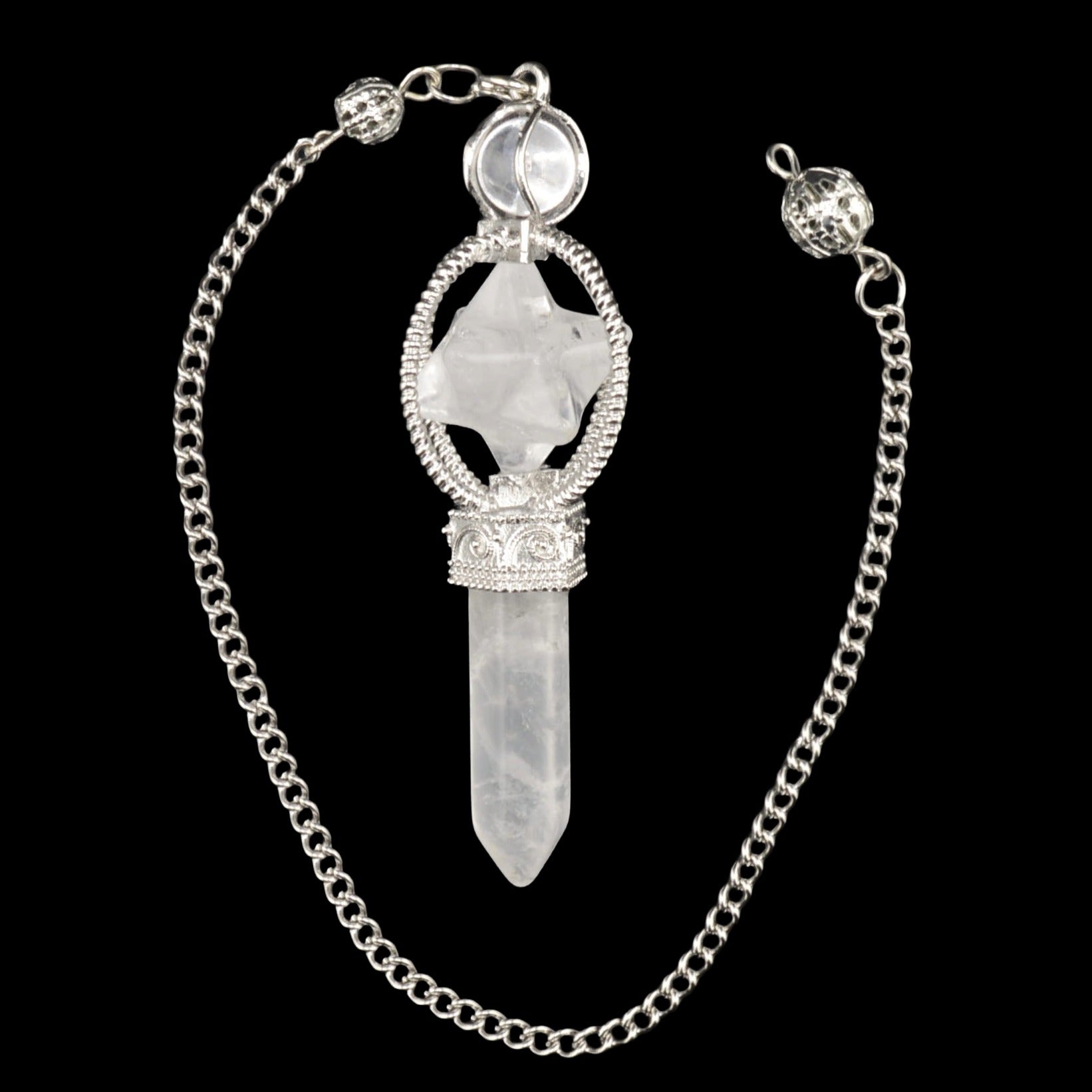 A silver-toned chain necklace featuring a pointed quartz crystal pendant and merkaba, a decorative silver filigree frame, and a round clear stone at the top, displayed against a solid black background.