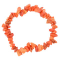 A circular beaded necklace made of irregular, chunky coral-orange stone chips, displayed on a clean white background.