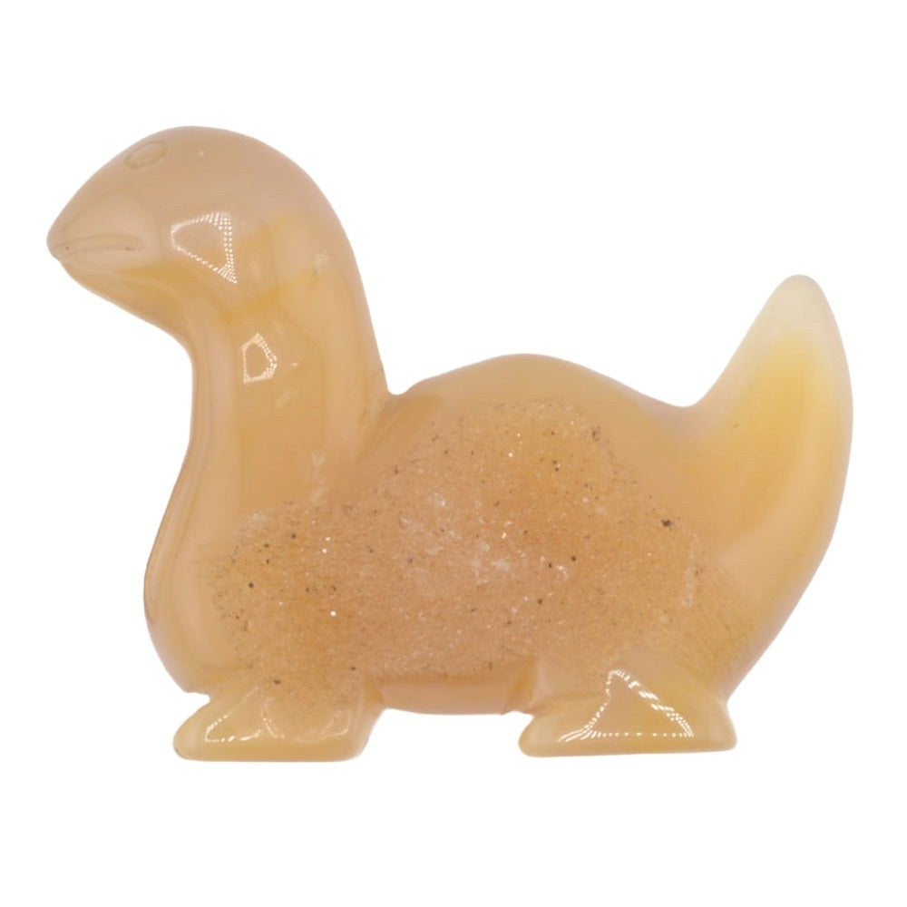 A small figurine of a dinosaur made from druzy agate peachy-yellow with embedded glitter, shown on a plain white background.
