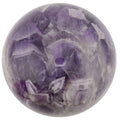 A polished purple amethyst crystal sphere with visible natural crystal facets and cloudy white inclusions, isolated on a white background.