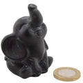 A 6cm black obsidian elephant figurine with its trunk raised, shown next to a gold coin for scale on a plain white background.