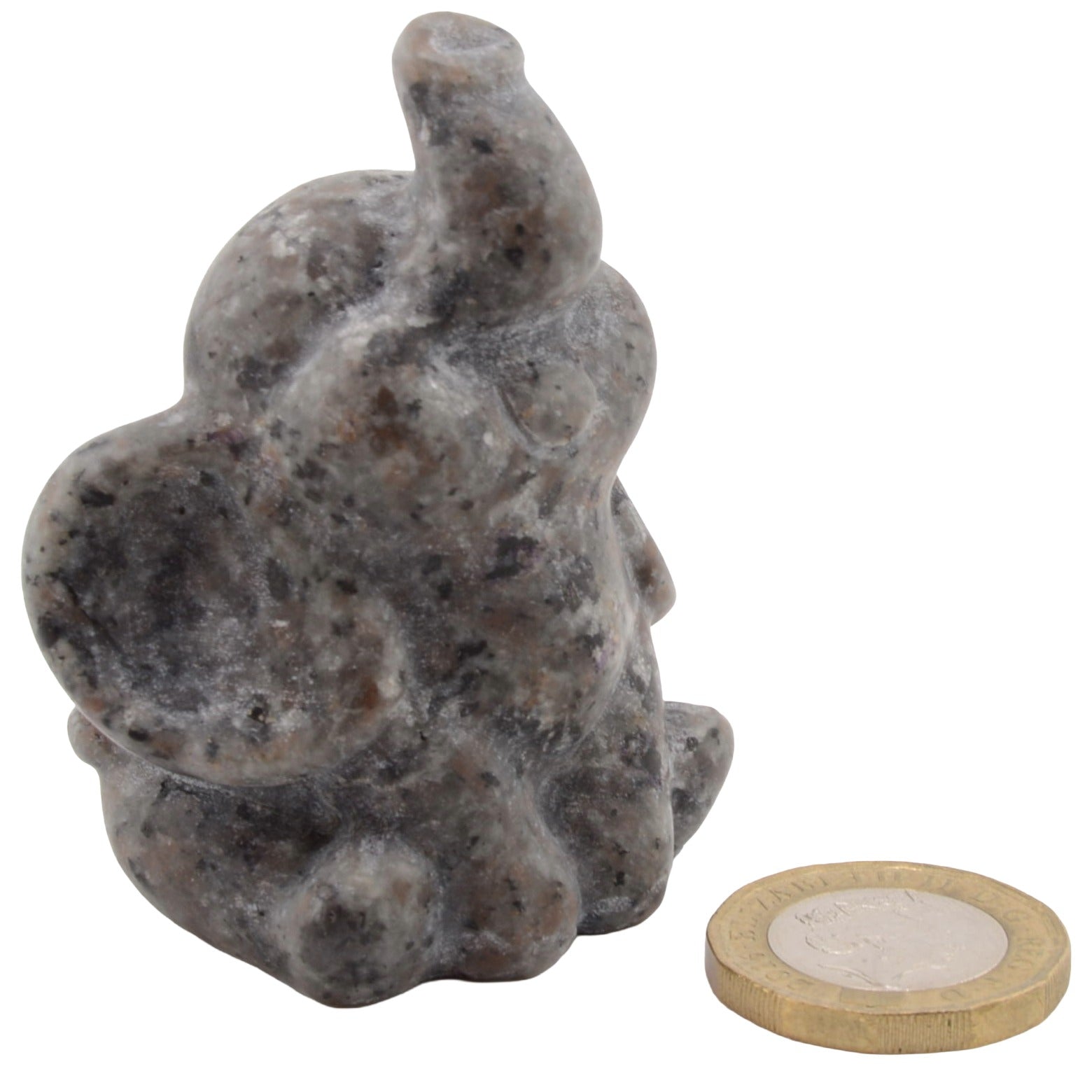 A small carved elephant figurine made of speckled gray yooperlite gemstone, shown next to a coin for scale on a plain white background. UV reactive