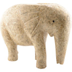 A carved elephant figurine made from natural beige and tan fossil stone, set against a plain white background.
