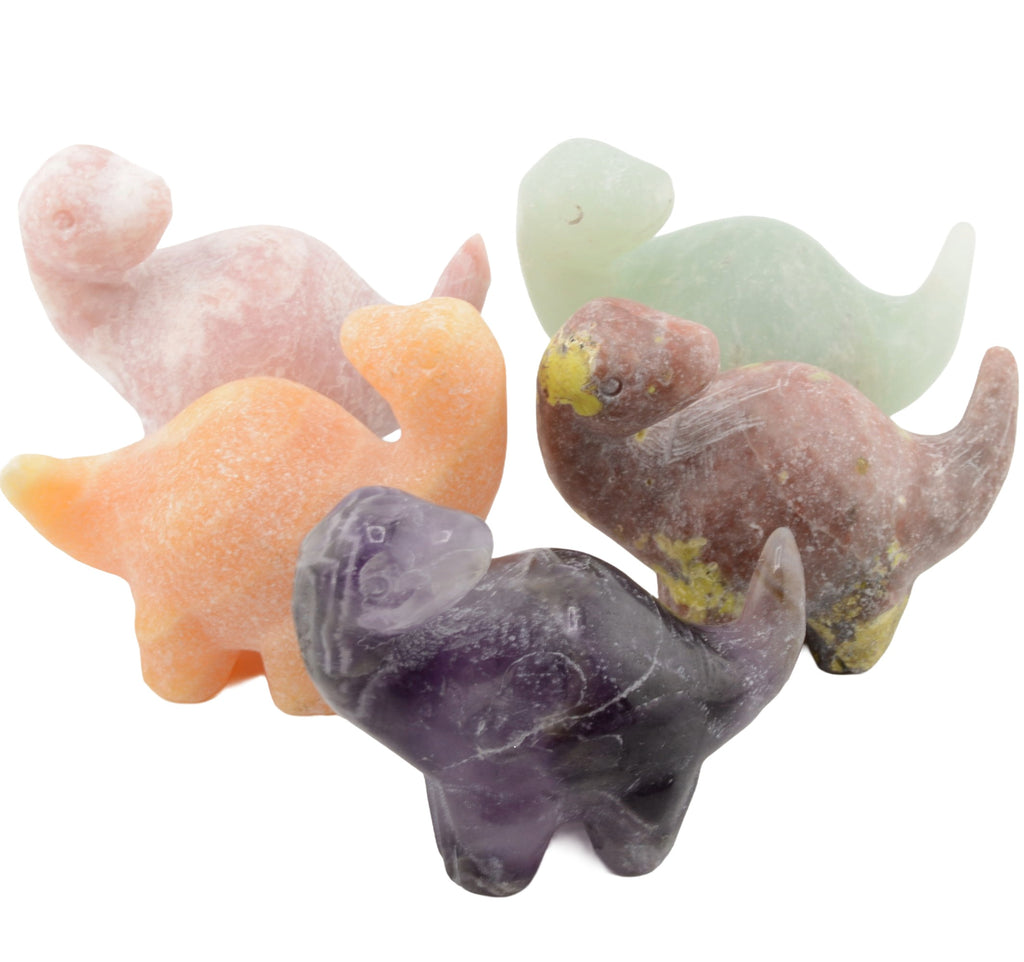 Five small carved gemstone dinosaur figurines in different colors, including pink, orange, purple, and green, arranged together on a plain white background.