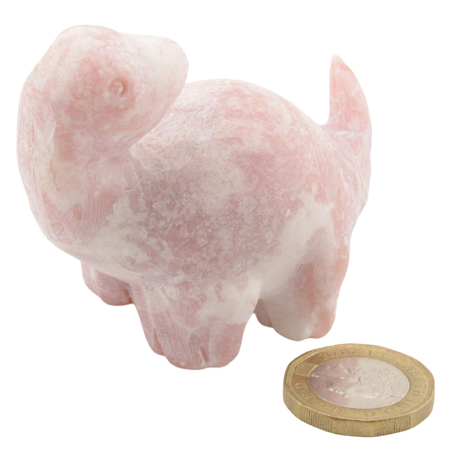 A small carved pink opal gemstone dinosaur figurine, shown on a plain white background with a coin placed in front for scale.