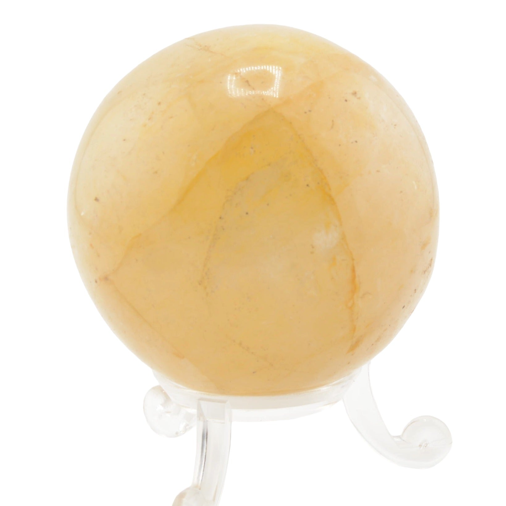 A polished yellow-orange golden healer quartz crystal sphere resting on a clear acrylic display stand, isolated on a white background.