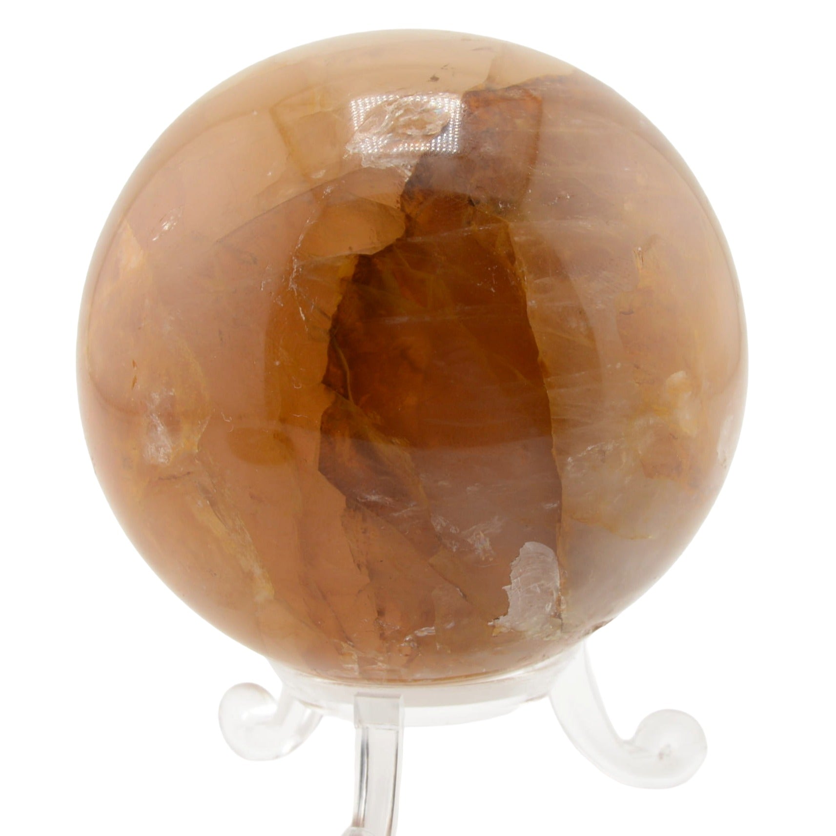 A polished golden healer quartzcrystal sphere on a clear acrylic display stand, set against a plain white background.