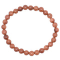 A beaded stretch bracelet made of 6mm goldstone gemstone beads with fine golden glitter, displayed on a clean white background.