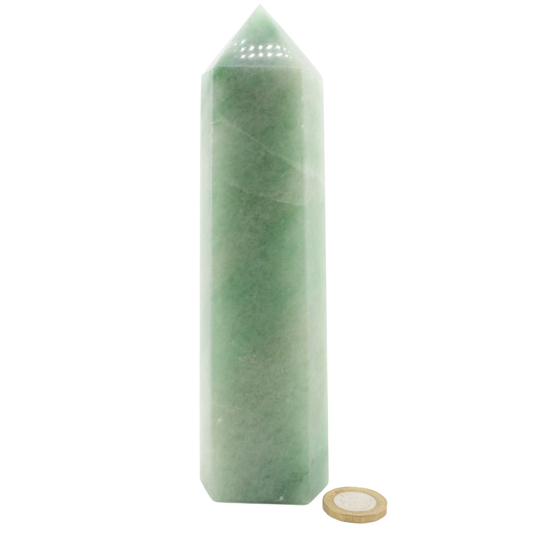 A green aventurine crystal tower with a pointed top, shown next to a gold coin for scale on a plain white background.