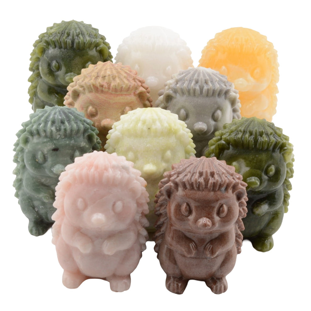 A set of small hedgehog figurines in multiple pastel and earthy colors, including green, pink, brown, beige, gray, white, and orange, arranged together on a plain white background.