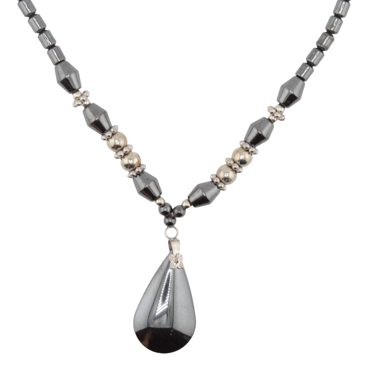 A beaded necklace featuring faceted dark gray heamatite crystal beads, small metallic silver beads, and a large teardrop-shaped dark gray haematite pendant with a silver geometric accent.