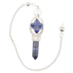 A silver-toned chain pendulum featuring a pendant with a faceted blue lapis lazuli crystal and a polished blue crystal point, set in silver-toned metal on a white background.