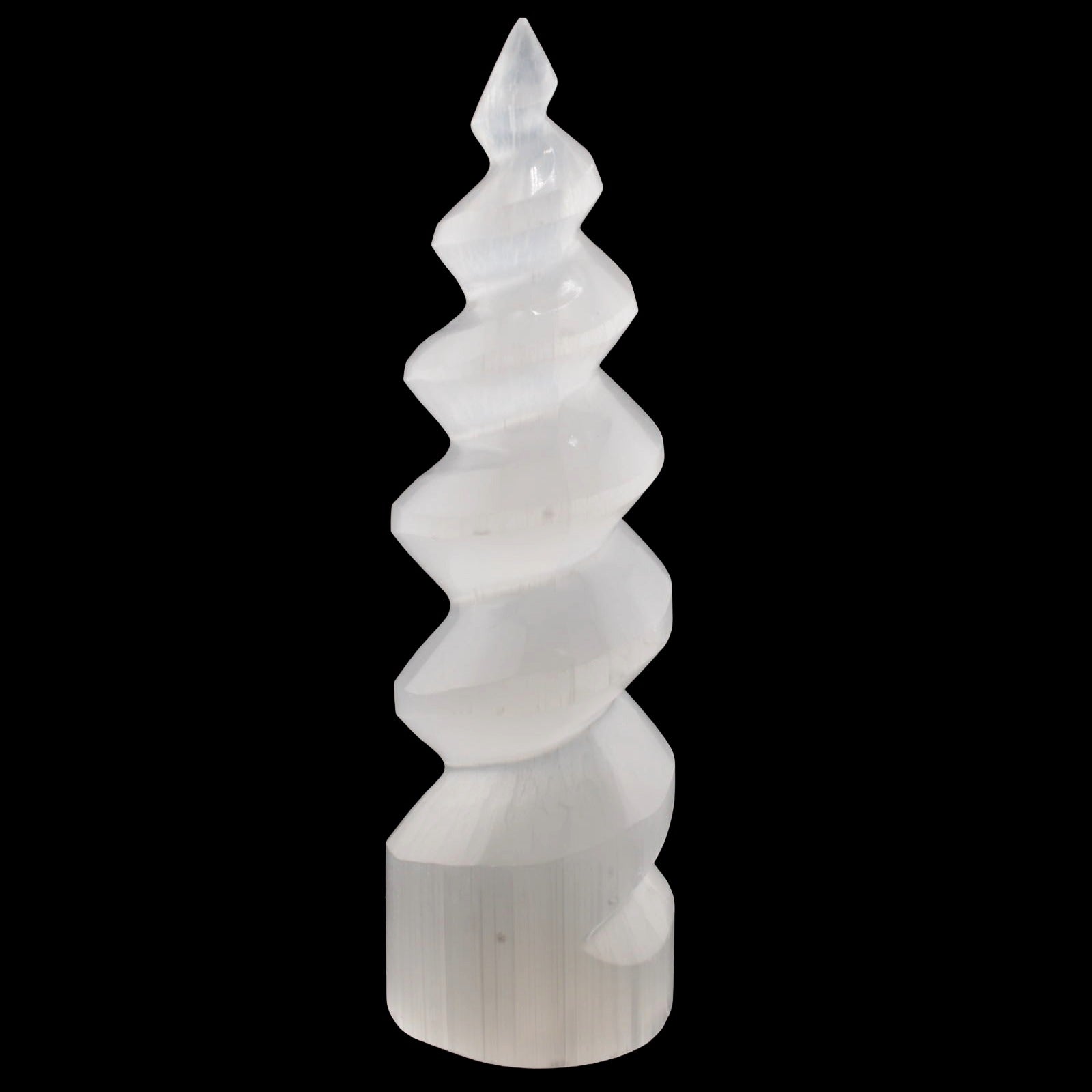 A white spiral-shaped selenite crystal tower sculpture made from selenite, photographed against a solid black background.