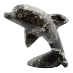A polished black and white marbled stone dolphin figurine, shown against a plain white background.