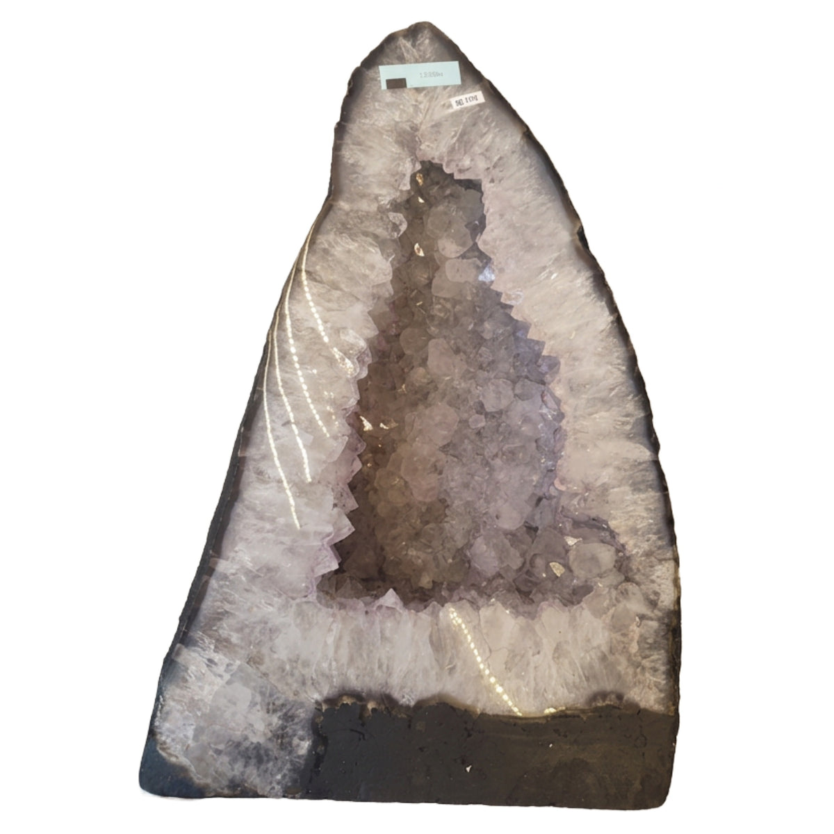 A large 225mm 13.25Kg natural amethyst geode specimen with a pointed triangular shape, featuring a dark outer matrix and a pale lavender-gray crystalline interior, photographed against a plain white background.