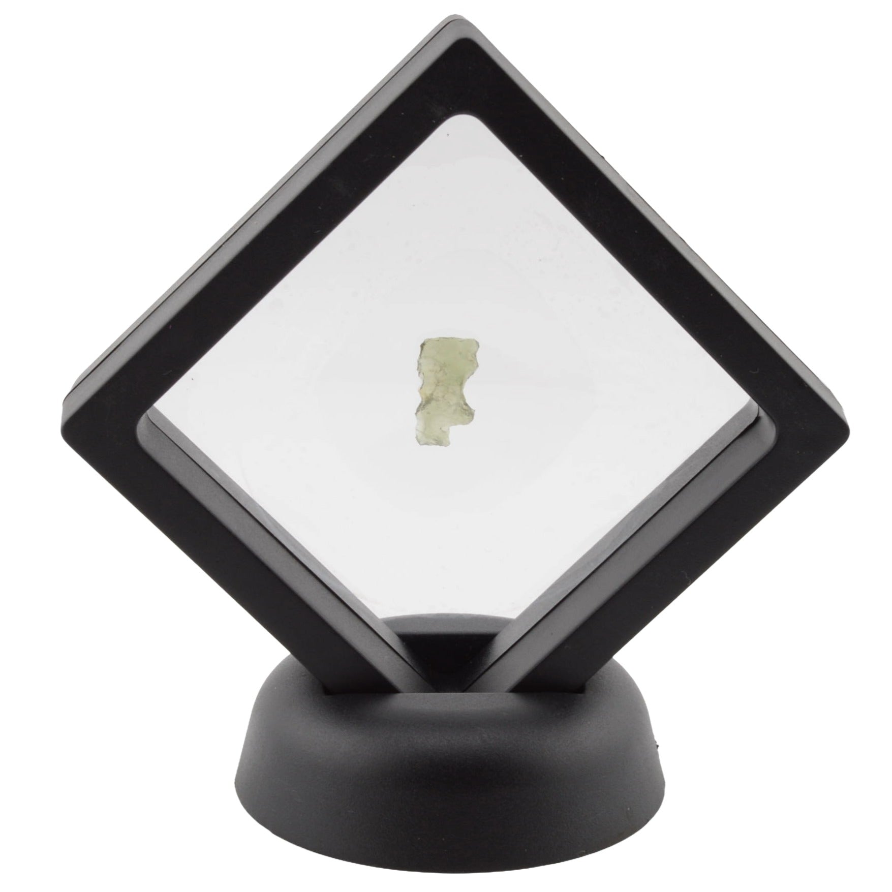 A moldavite specimen mounted inside a  diamond-shaped black floating display case, set on a round black base against a plain white background.