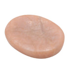 A smooth, polished peach-colored stone slab with natural mineral veining, photographed on a solid white background.