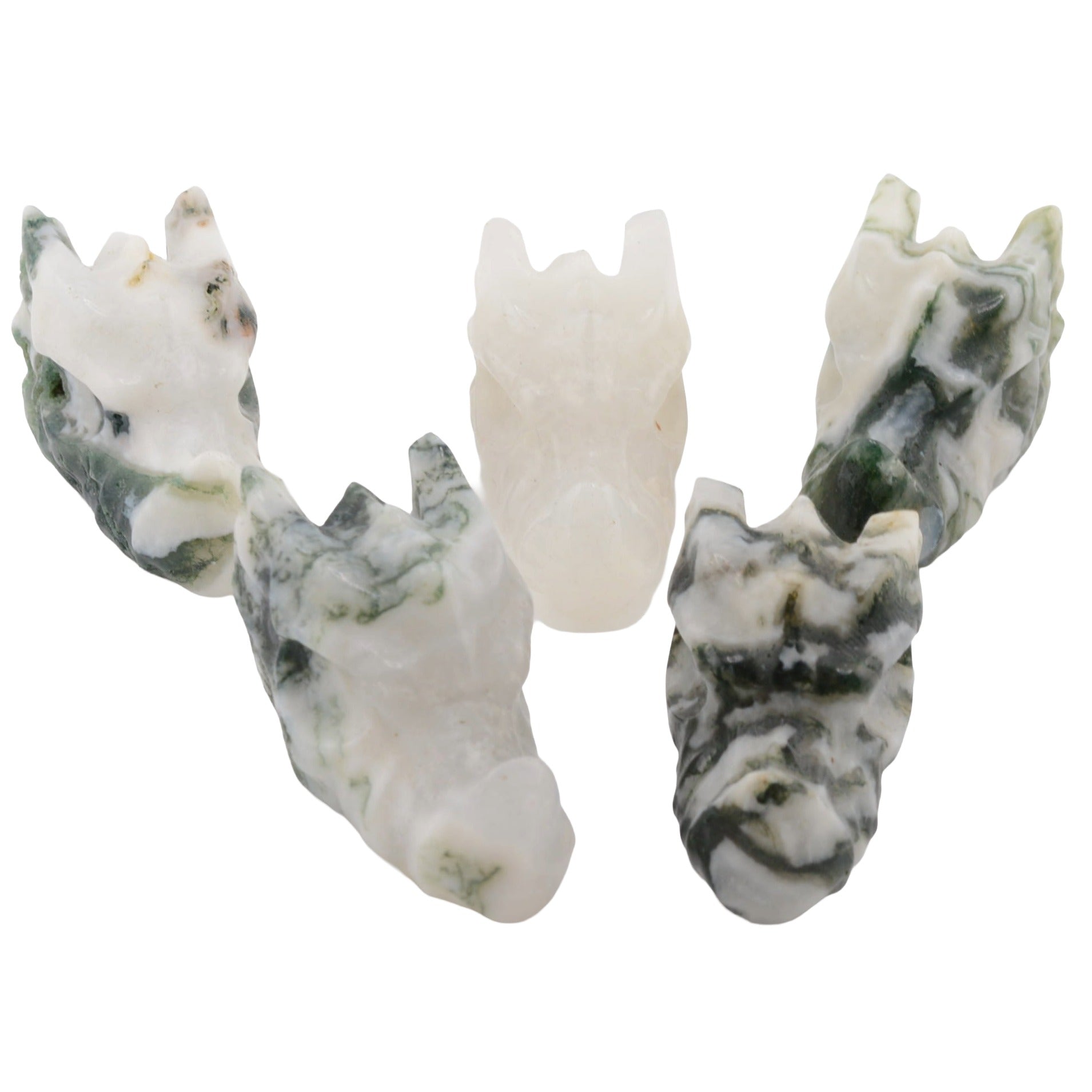 five carved moss agate dragon head figurines, coloured white and green marbled, arranged on a plain white background.
