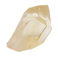 A raw, uncut pale yellow natural citrine crystal with natural facets and internal inclusions, isolated on a solid white background.