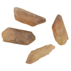 Four raw, natural citrine crystal points in a warm, translucent honey-amber color, arranged on a plain white background.