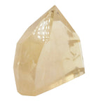 A faceted natural citrine crystal point, wighing 100g, in a pale yellow or citrine color, shown on a plain white background.