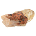 A raw mineral specimen featuring a pale yellow natural citrine crystal with a prominent central area of rusty orange-brown matrix and dark black inclusions, isolated on a white background.