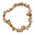 A beaded stretch bracelet made of small, irregular natural picture jasper stones in earthy tan, brown, and beige tones, arranged in a circle on a plain white background.