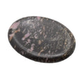 A polished oval rhodonite gemstone worry stone featuring a mottled pattern of black, gray, and pink with subtle beige veins, set against a plain white background.