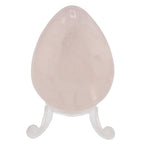 A polished rose quartz crystal egg displayed on a small clear acrylic stand against a plain white background.