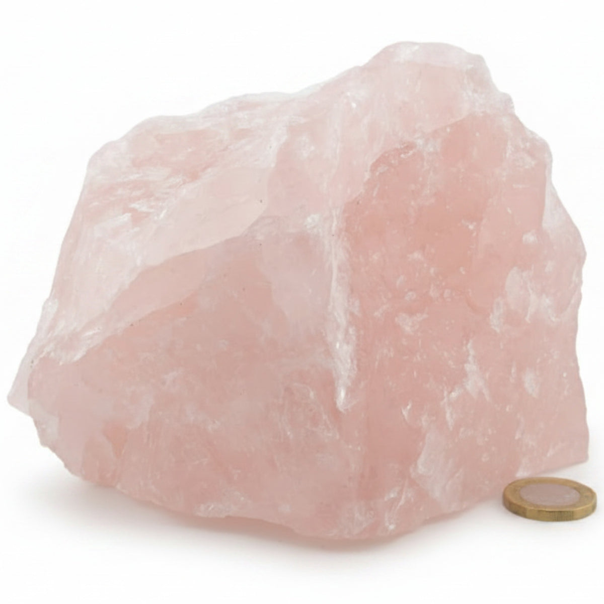 A rough pink rose quartz crystal with a small coin placed next to it for scale, shown on a clean white background.