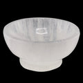 A translucent 100mm white crystal bowl, made of selenite, shown against a solid black background.