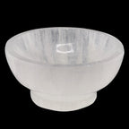 A translucent 100mm white crystal bowl, made of selenite, shown against a solid black background.