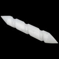 A selenite wand cylindrical tool with pointed ends, shown diagonally against a solid black background.