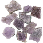 A group of rough amethyst crystal clusters with natural jagged edges, showing various shades of purple and lavender, isolated on a white background.