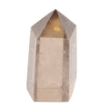 A natural smoky quartz crystal point with a hexagonal shape, featuring a warm golden-brown hue concentrated near the top apex, set against a solid white background.