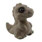 A small dinosaur T-Rex figurine made of gemstone , featuring a dark gray-brown body and glossy black eyes, isolated on a white background.