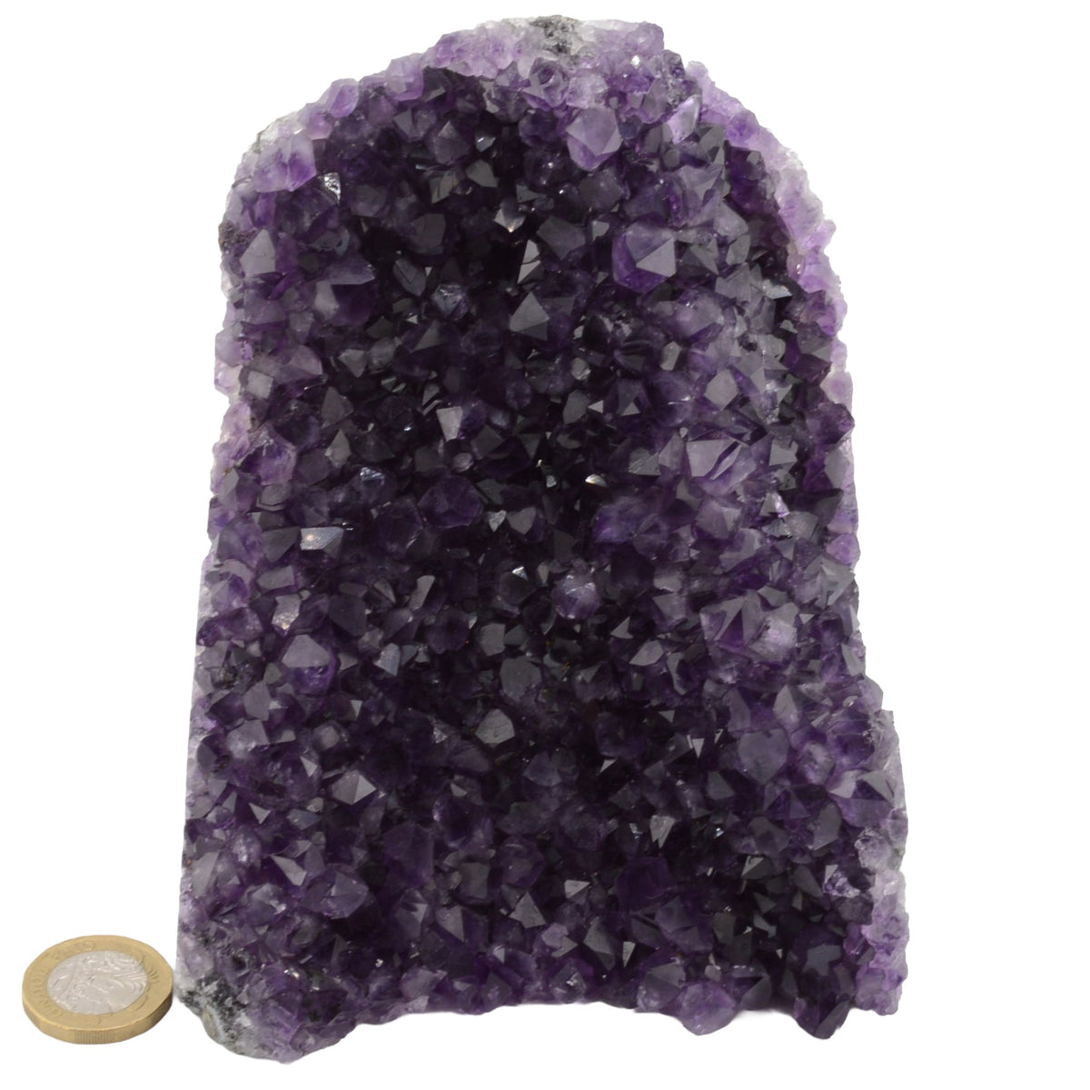 A natural amethyst crystal cluster 1.5Kg specimen with a rough, unpolished surface, shown on a plain white background with a small coin for scale.